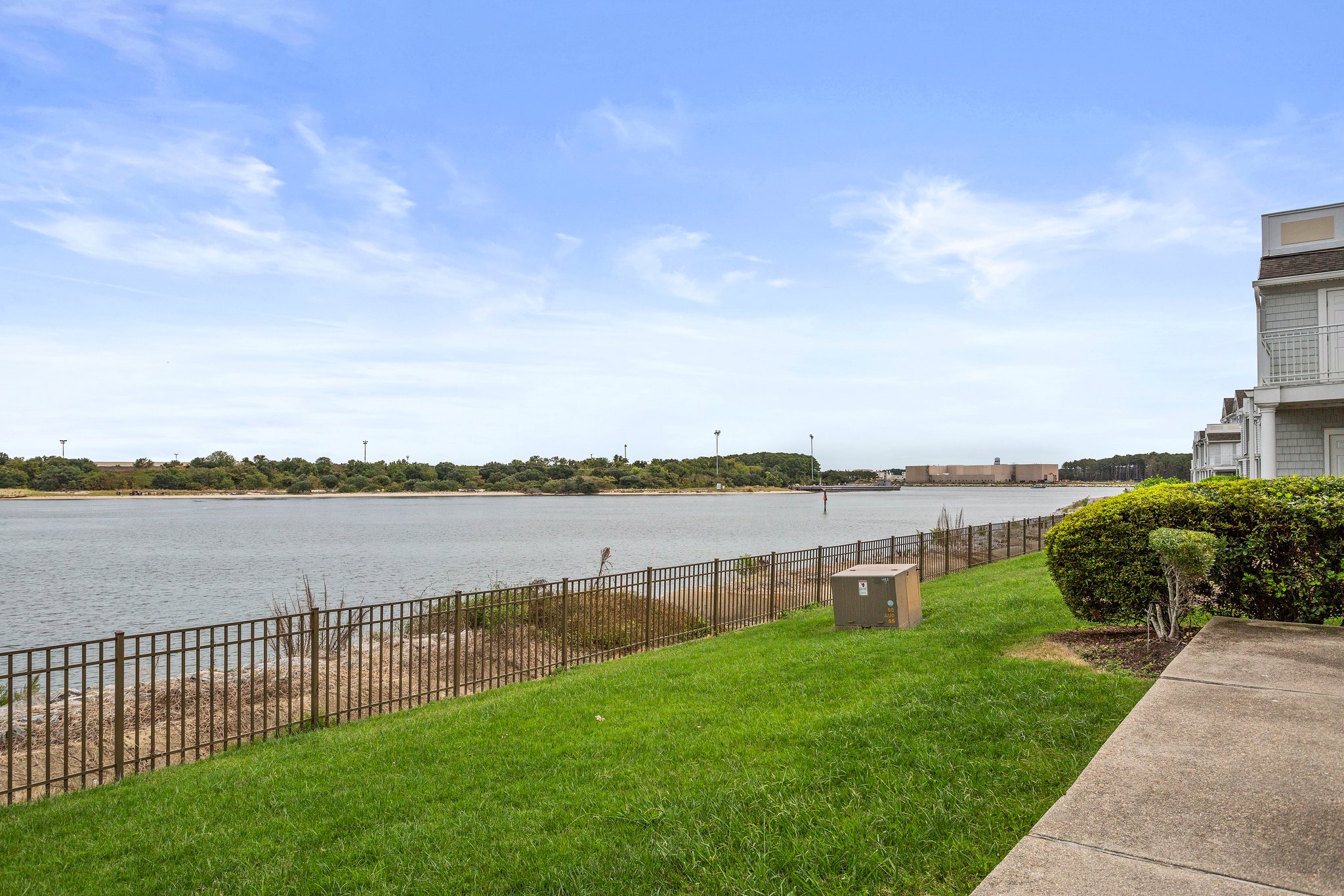 Spacious grassy area with serene water views