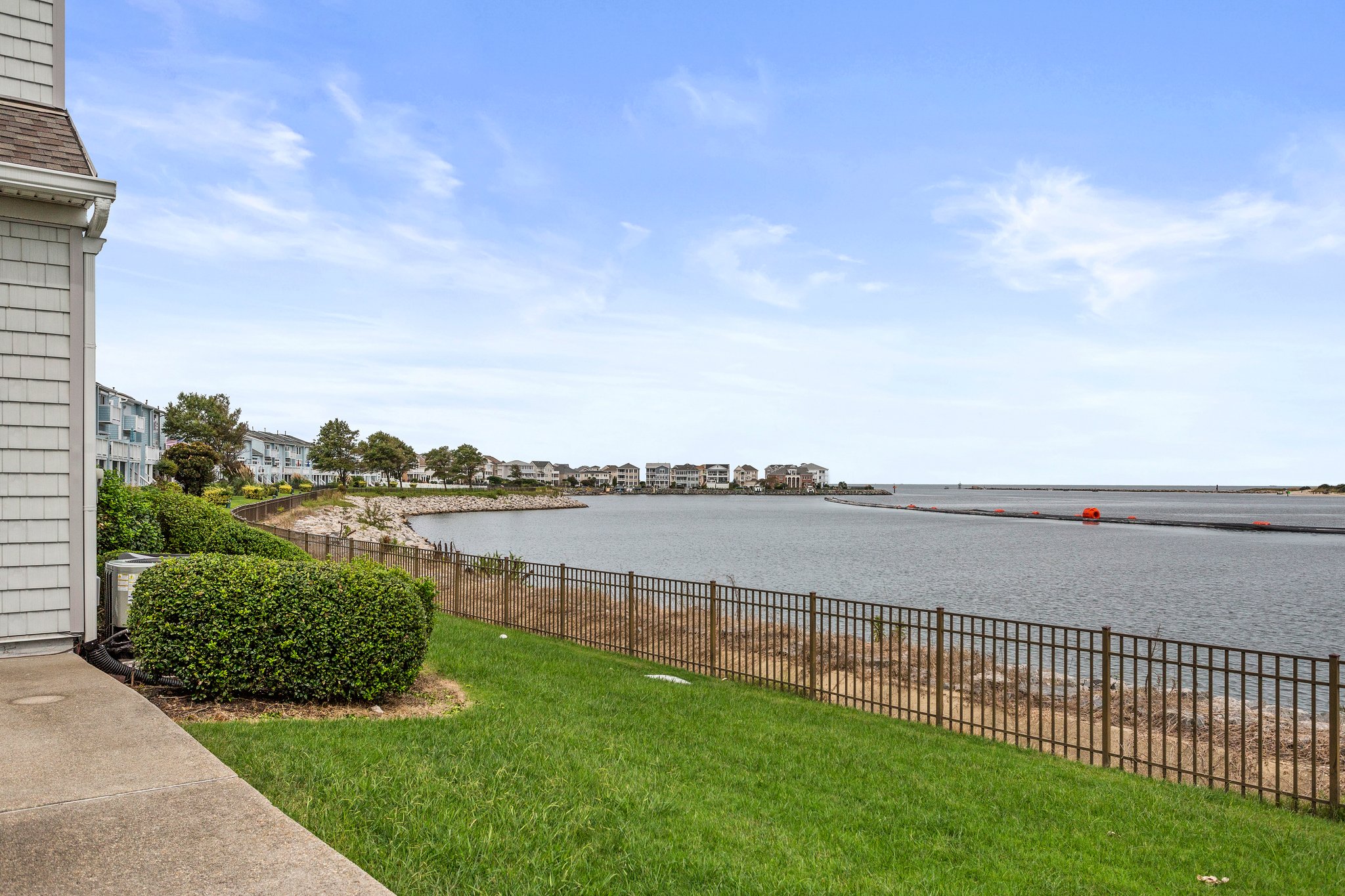 Spacious grassy area with serene water views