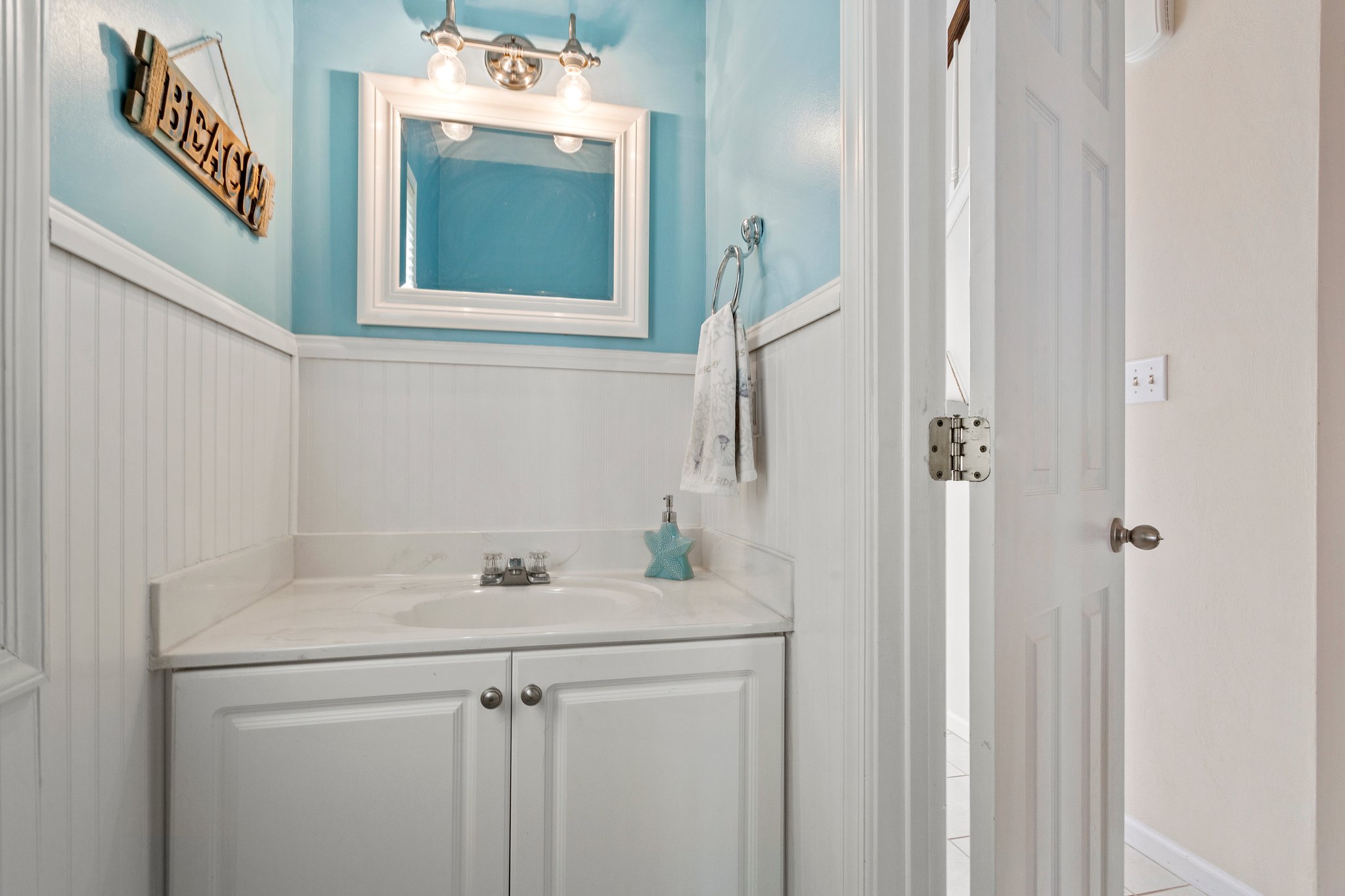 Convenient Downstairs half bathroom with modern fixtures and a stylish touch