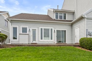 Large patio with storage and grassy area, ideal for enjoying water views and peaceful outdoor moments