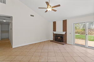 Family room with cozy fireplace and high ceilings