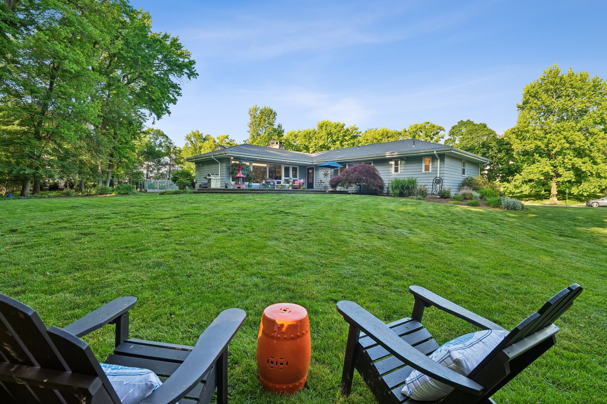 Most backyards end at a fence line. Here, the landscape simply unfolds. Mature trees, open lawns, winding paths, and protected green space become part of everyday life, creating a setting that feels more like a private estate than a suburban home.