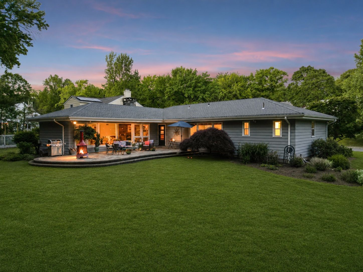 As dusk settles over the park, the property takes on an entirely different character. The lights begin to glow, the trees soften into silhouette, and the patio becomes one of the most enchanting places to spend an evening in Upper Montclair.