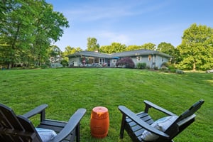 Most backyards end at a fence line. Here, the landscape simply unfolds. Mature trees, open lawns, winding paths, and protected green space become part of everyday life, creating a setting that feels more like a private estate than a suburban home.