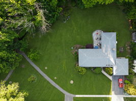 The aerial perspective tells the story better than words ever could: this home enjoys one of the most remarkable natural settings in Upper Montclair.