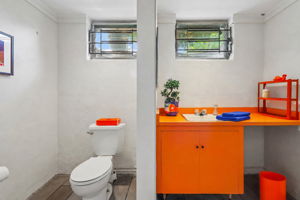 Unexpected pops of color make even the practical spaces memorable. Not saying the Knicks inspired this lower level bathroom... but we're not saying they didn't.
