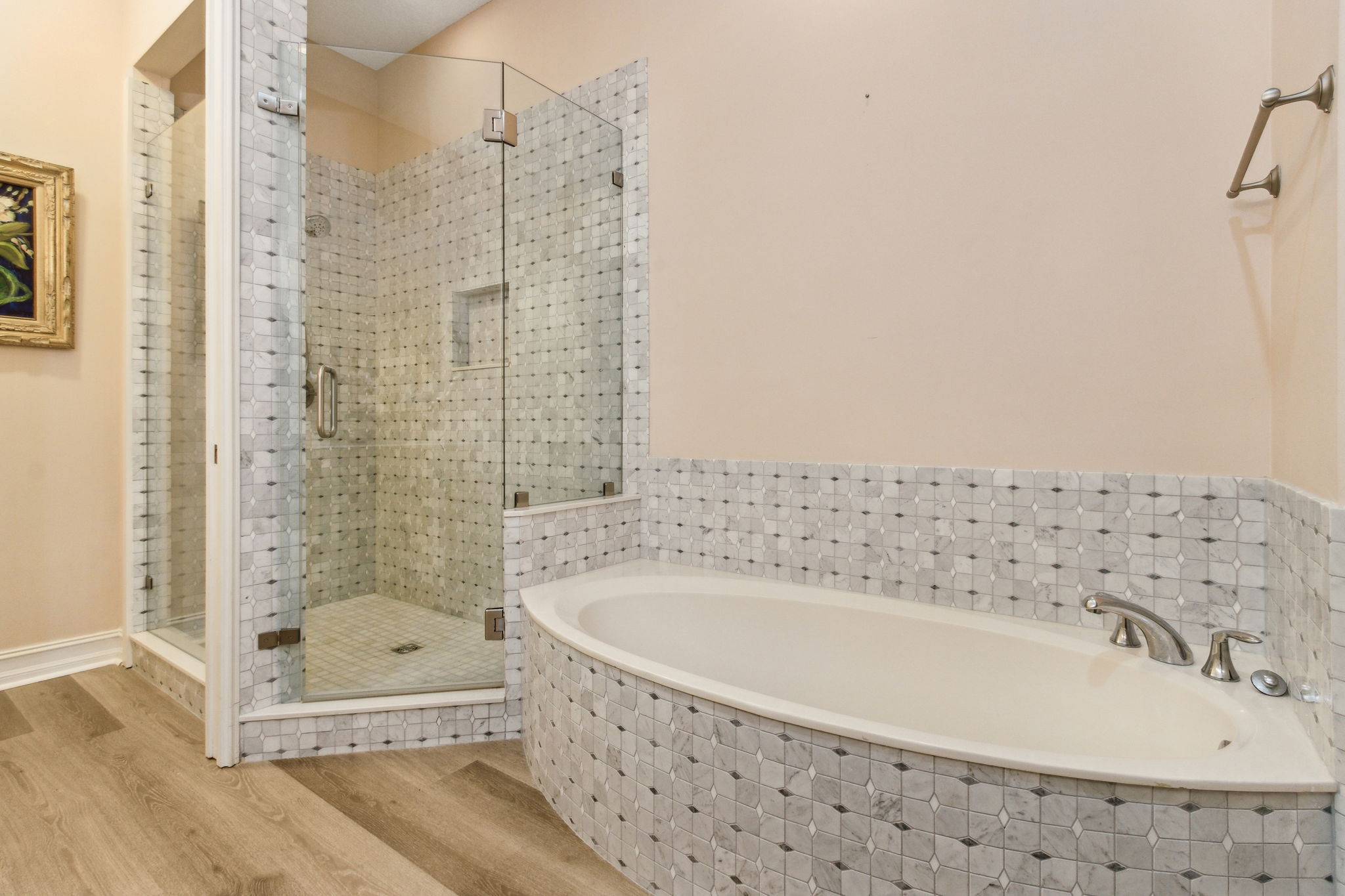 Unwind in a soaking tub framed in marble tile ...