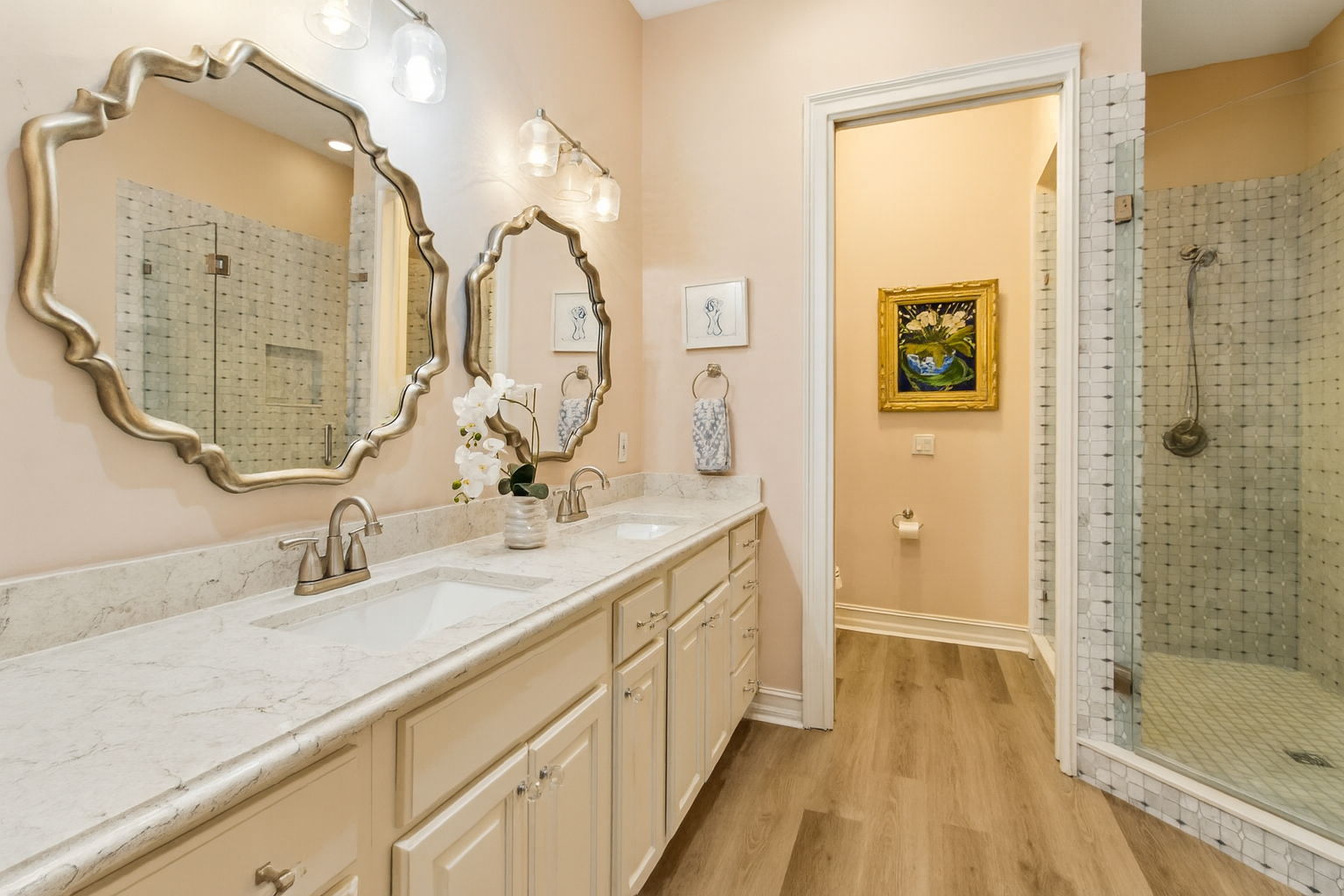 Mirrors, lighting, and fixtures were carefully selected to deliver a cohesive, high-design look that is as chic as it is distinctive.