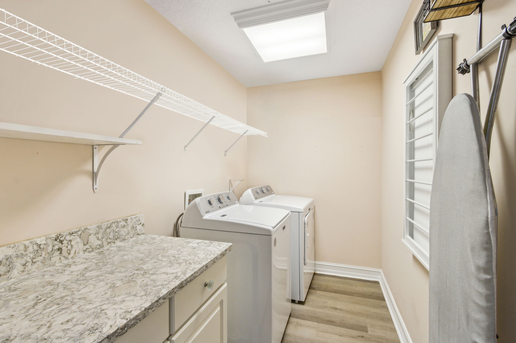 The 2nd floor laundry room is large enough for both daily tasks and extra storage.