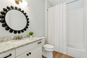 The home’s high-design aesthetic carries gracefully into both guest baths.