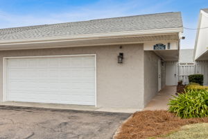 2 car garage with storage and entrance to courtyard