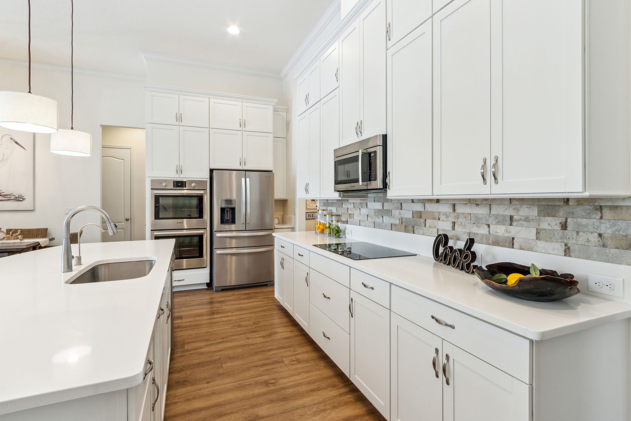 You'll enjoy the fresh, sunlit kitchen with a modern white palette...