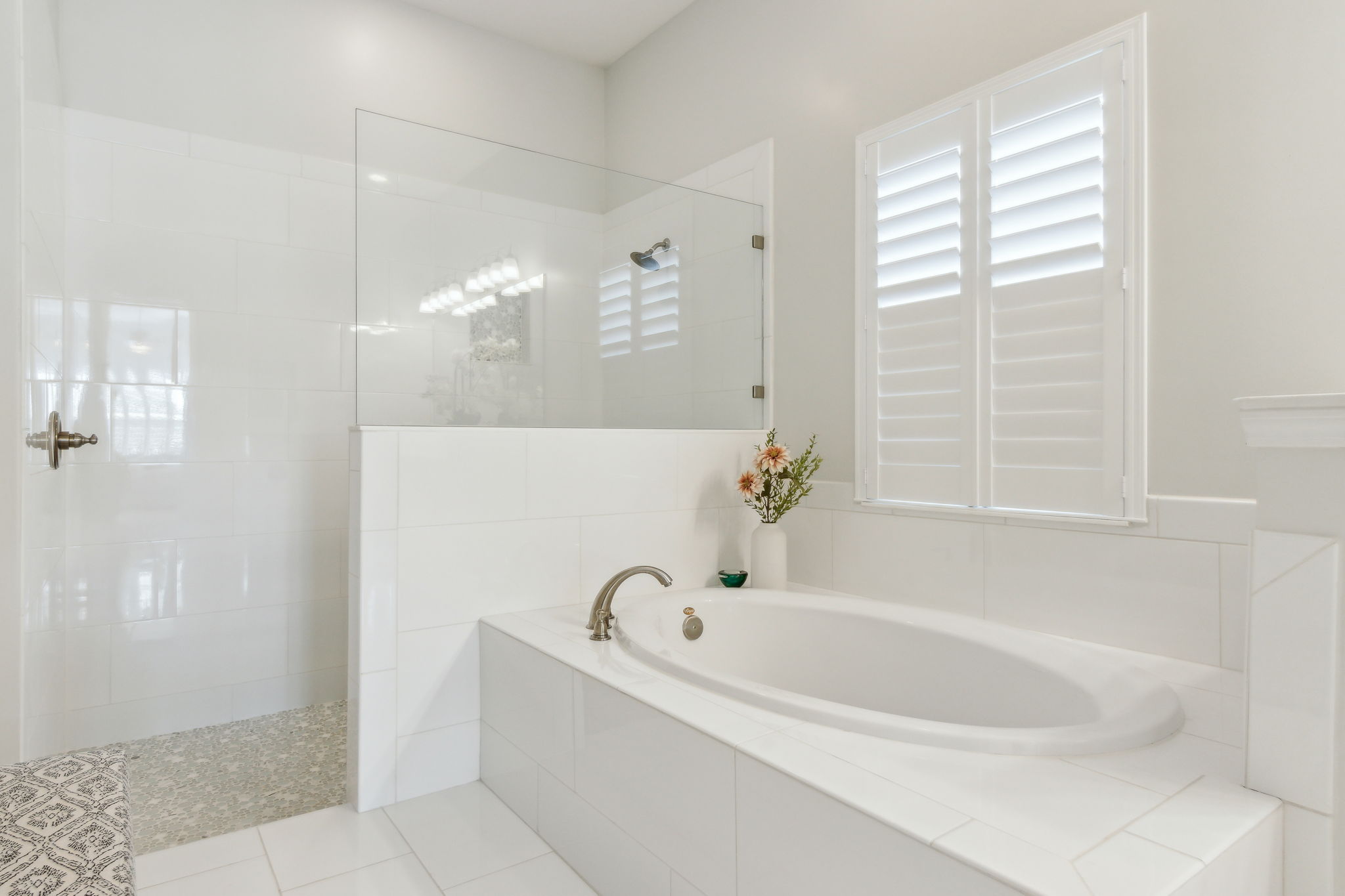 ...featuring a soaking tub and an impressive frameless enclosed shower.