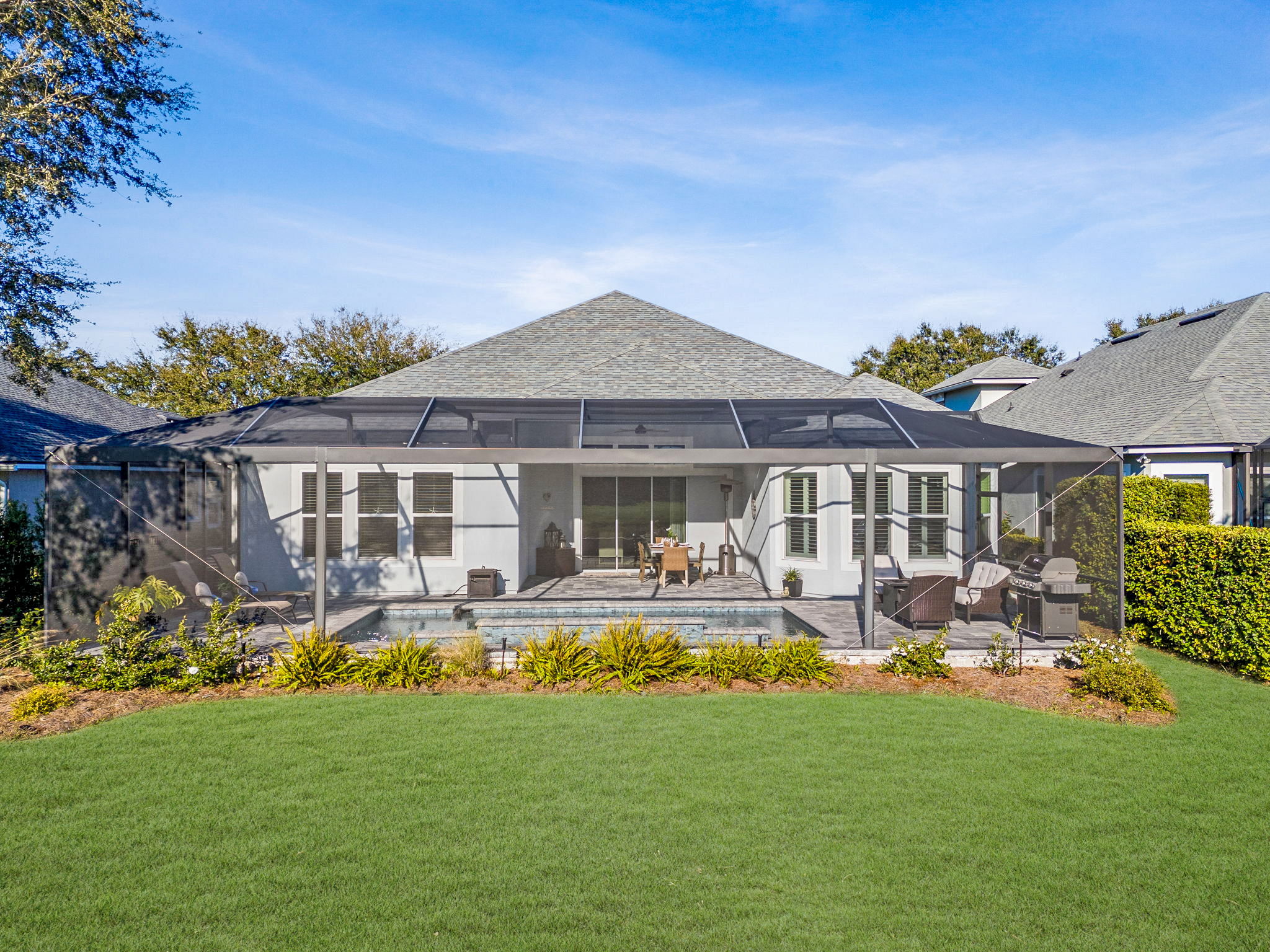 The home is surrounded by picturesque, mature landscaping on a high, dry lot safely outside a flood zone.