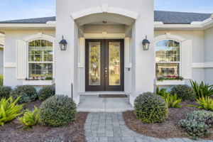 A paver pathway leads you to a covered porch ...