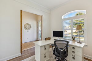 The first office is delightfully accented by a custom barn door entrance.