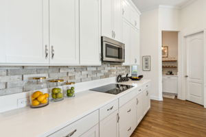 The kitchen features plenty of sparkling quartz countertops for meal preparation...