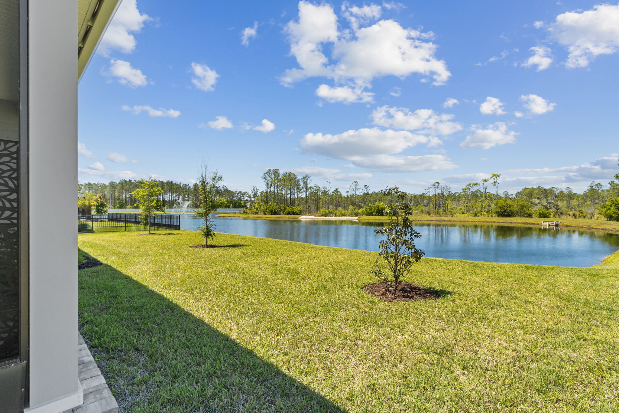 Enjoy serene backyard living with stunning pond views.