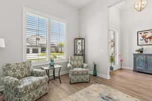 The bright front room offers flexibility as a den or office.