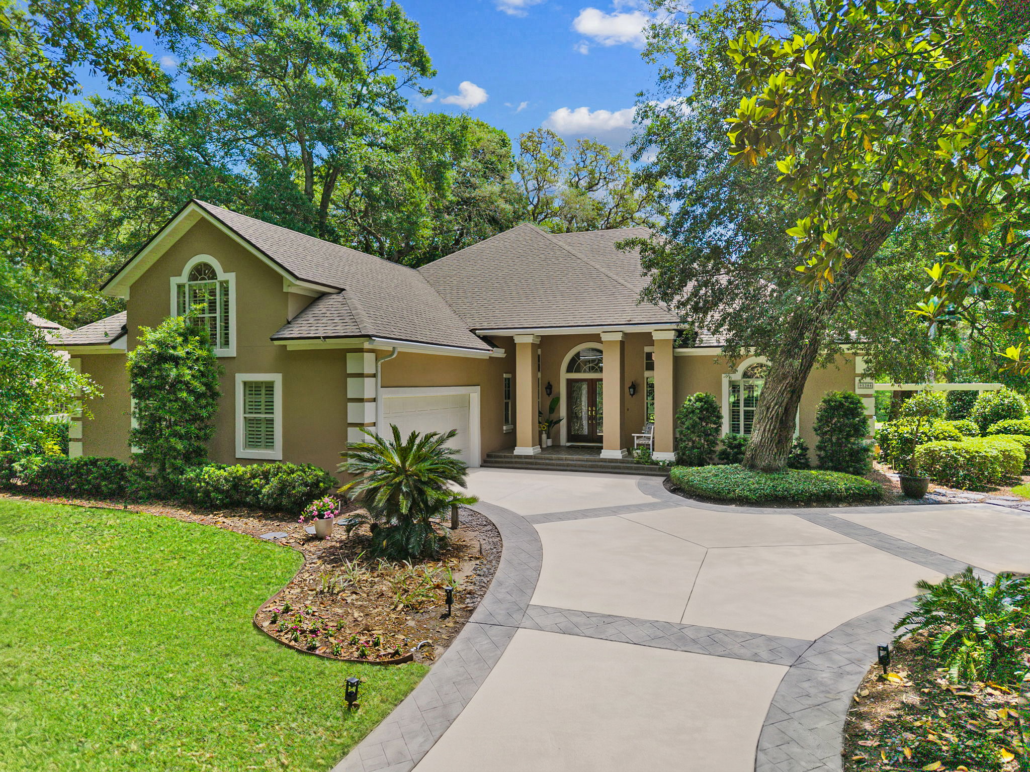 A gracious golfside setting, wrapped in mature trees and quiet curb appeal…
