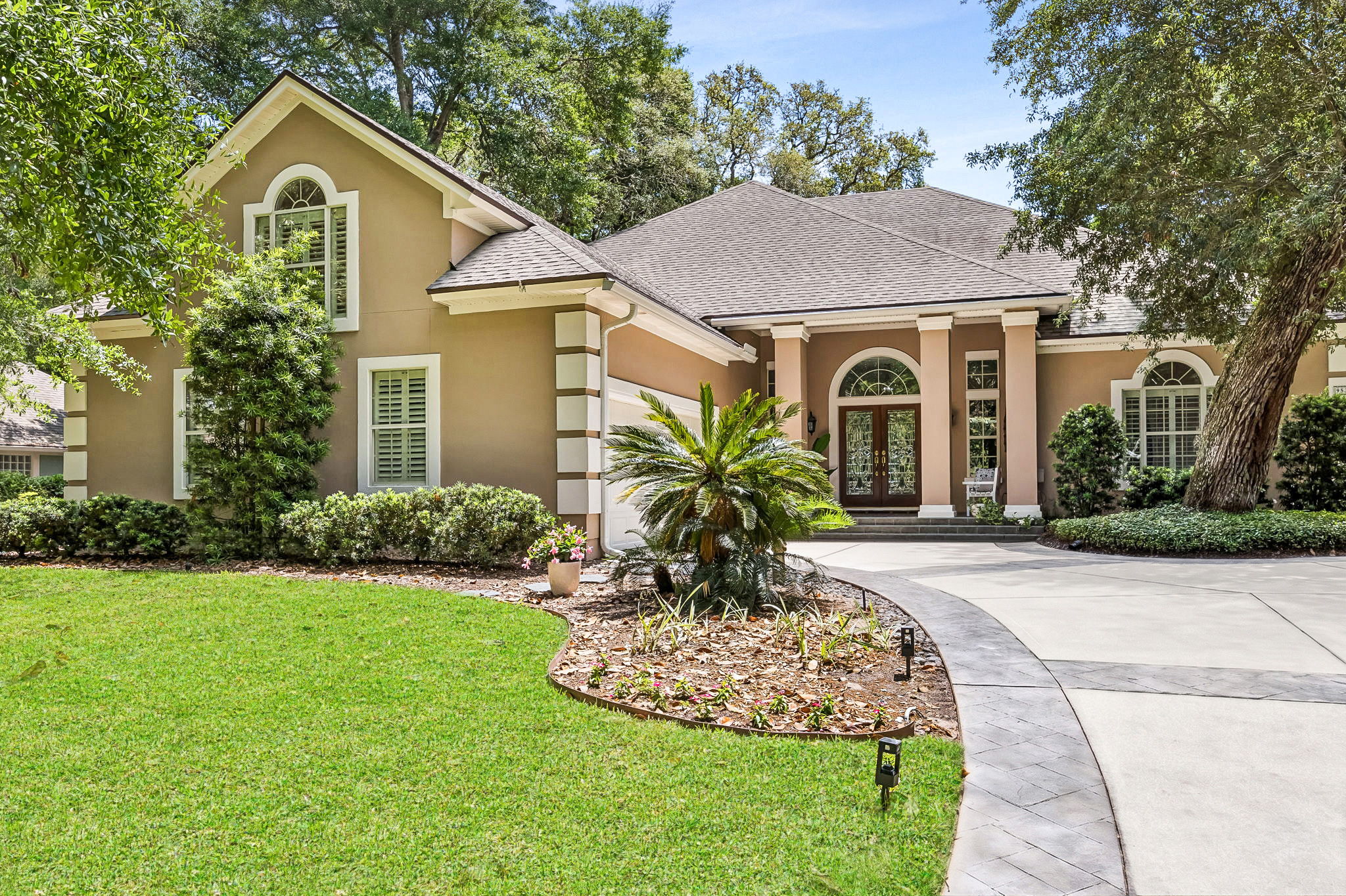 Set beneath a canopy of oaks, the home makes an elegant first impression…
