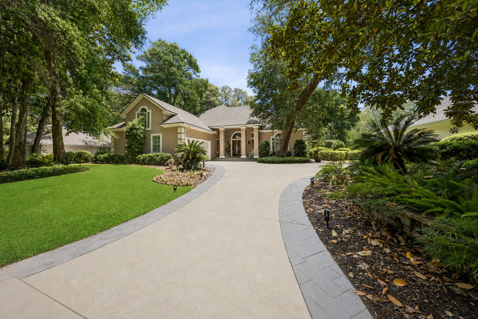 …with a sweeping circular drive and lush landscaping that feel private, polished, and welcoming.