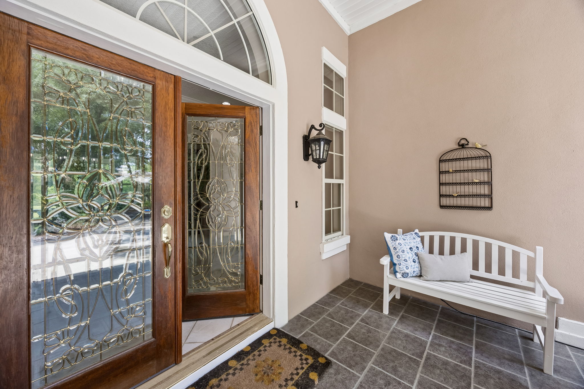 The covered entry sets a quieter tone — gracious, sheltered, and thoughtfully designed.