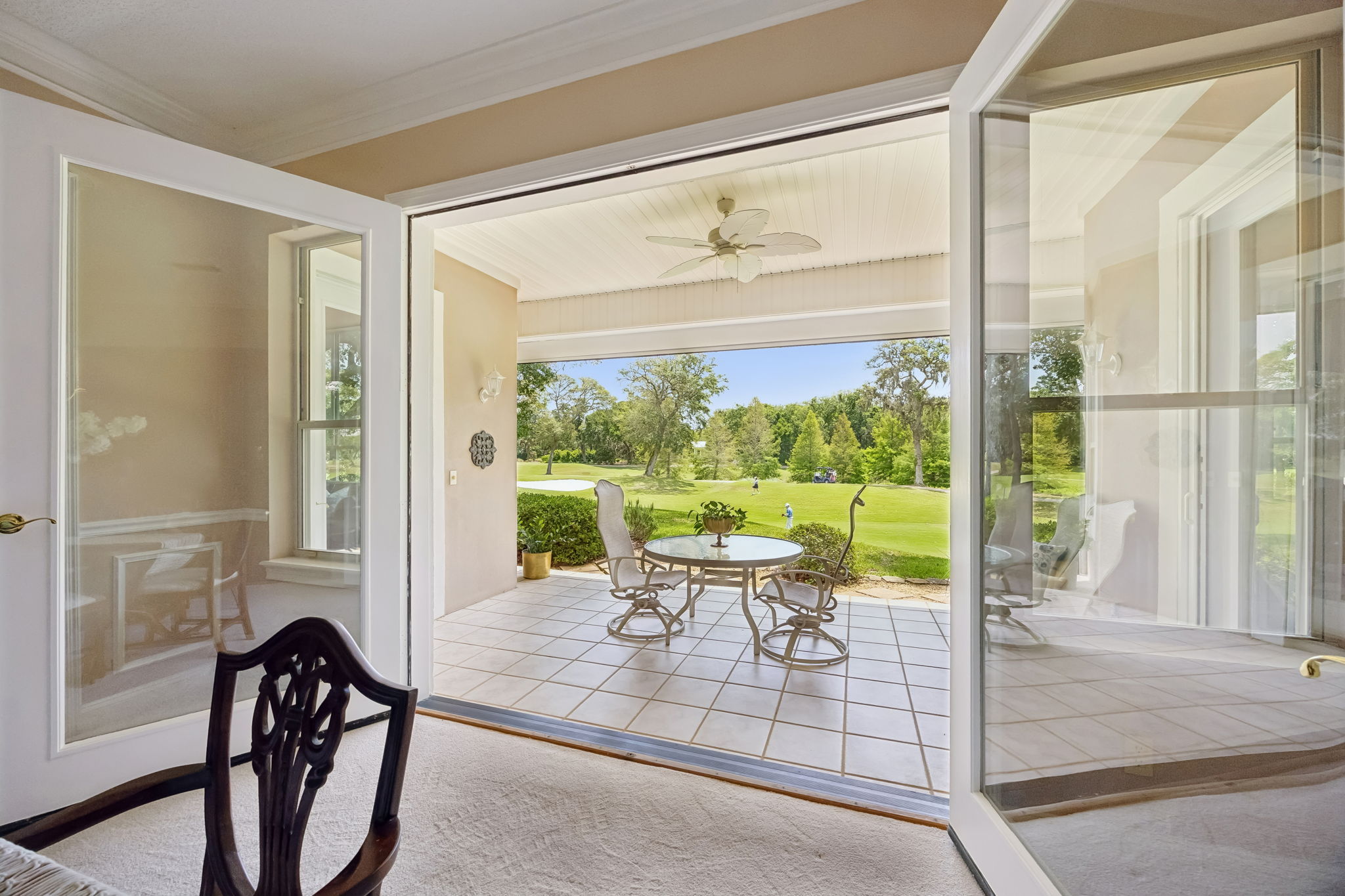 Walls of glass open the room to the covered patio creating an easy indoor-outdoor flow.