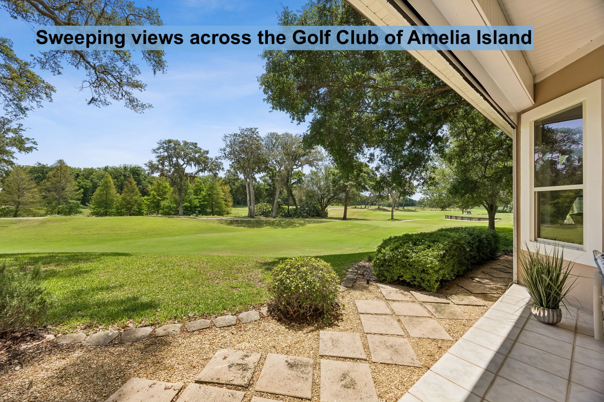 Sweeping views across the Golf Club of Amelia Island make the backyard feel expansive and serene.