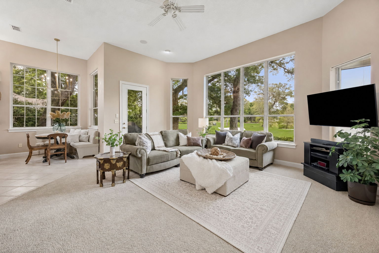 The main living area is wrapped in windows, pulling the golf course views deep into the home.
