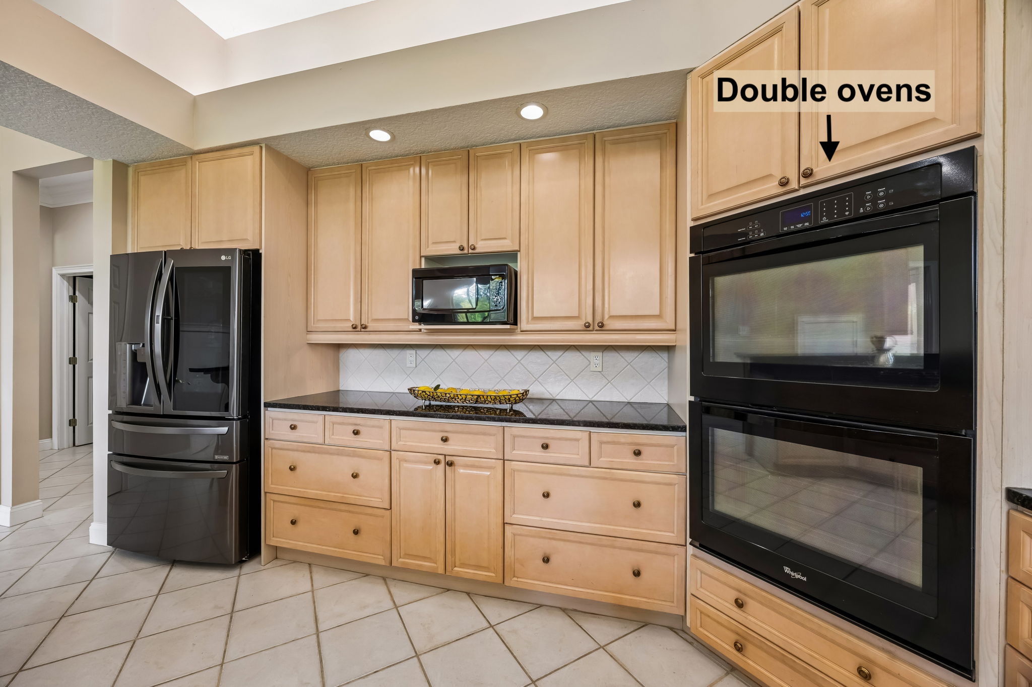 A wide appliance wall and abundant storage keep the kitchen practical, polished, and ready for real use.