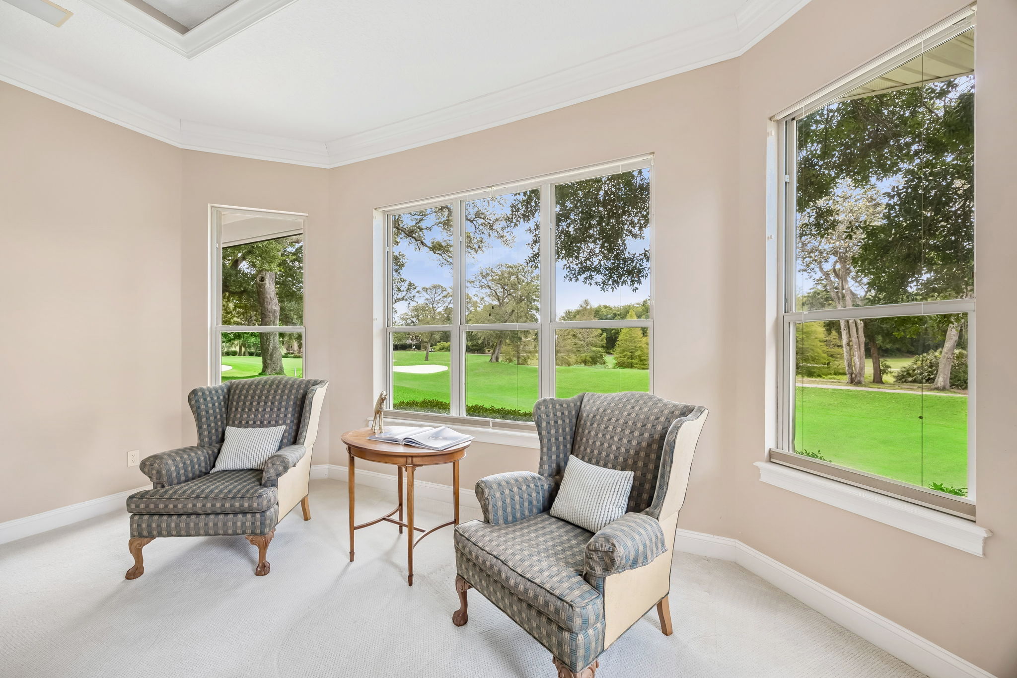 A sitting area framed by fairway views creates a quiet spot to read, recharge, or start the morning slowly.