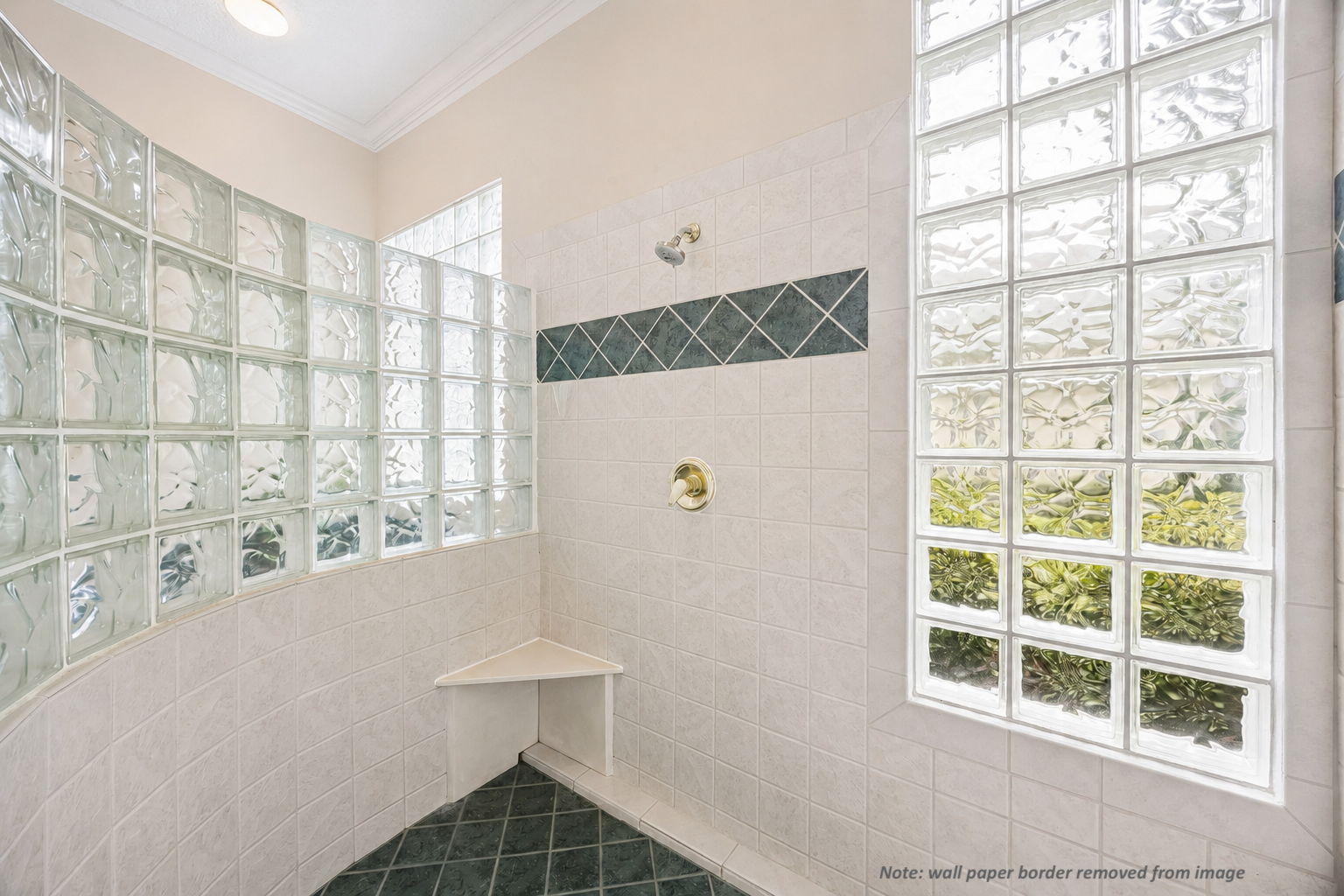 The walk-in shower is filled with soft filtered light, adding a bright, airy feel to the suite.