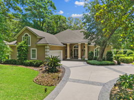 A gracious golfside setting, wrapped in mature trees and quiet curb appeal…