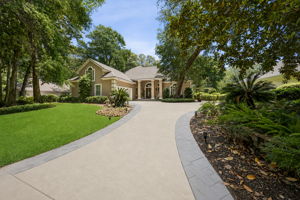 …with a sweeping circular drive and lush landscaping that feel private, polished, and welcoming.