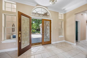 …where the entry opens with light, height, and a graceful transition into the home beyond.