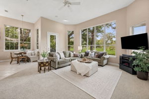 The main living area is wrapped in windows, pulling the golf course views deep into the home.