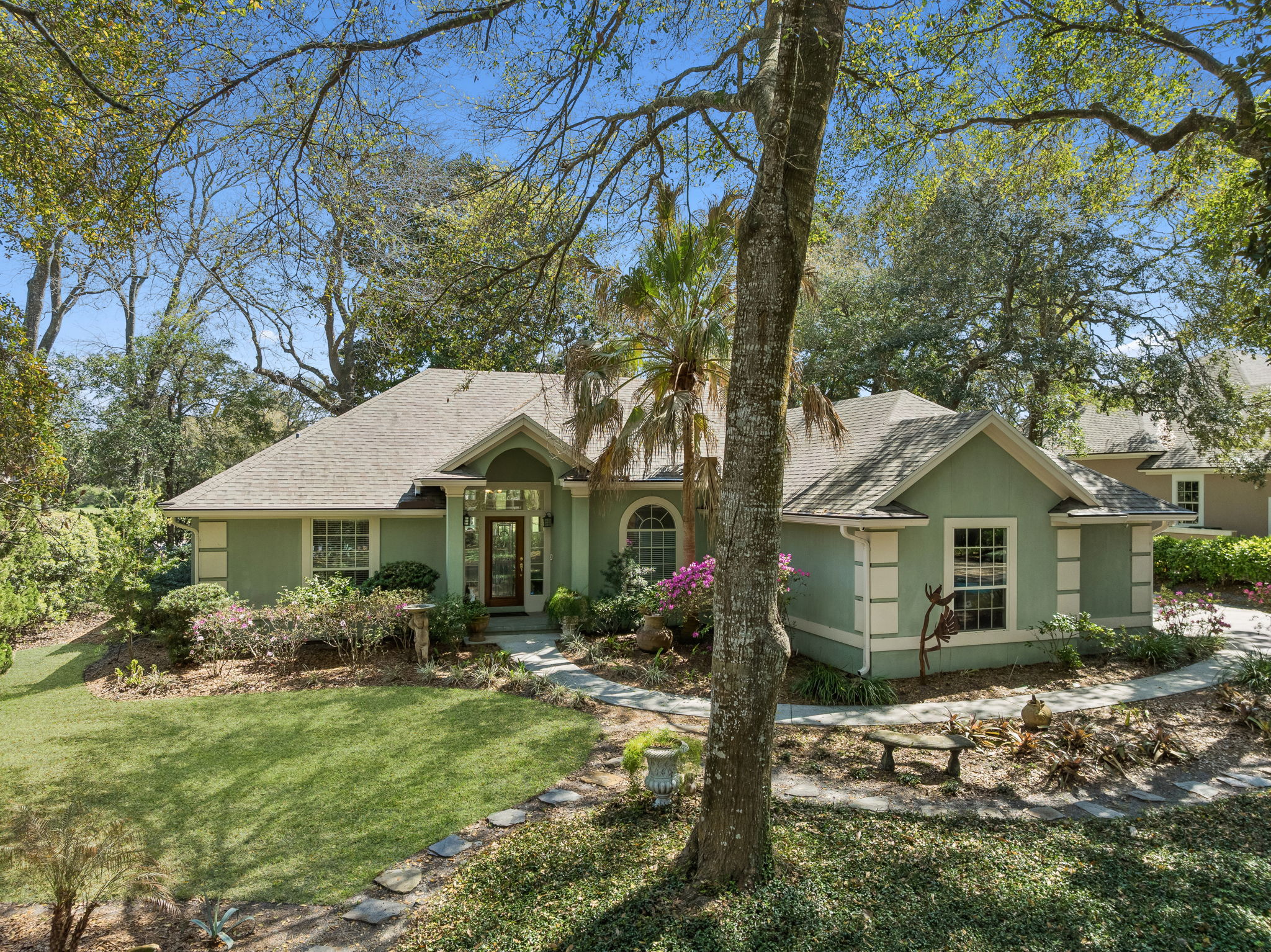 Tucked beneath a canopy of mature trees, the home makes a graceful first impression.