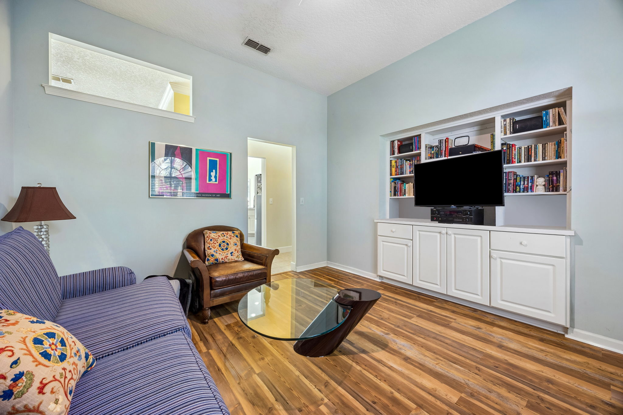 A flexible secondary living area currently serves as an office and den, but can easily function as a bedroom.