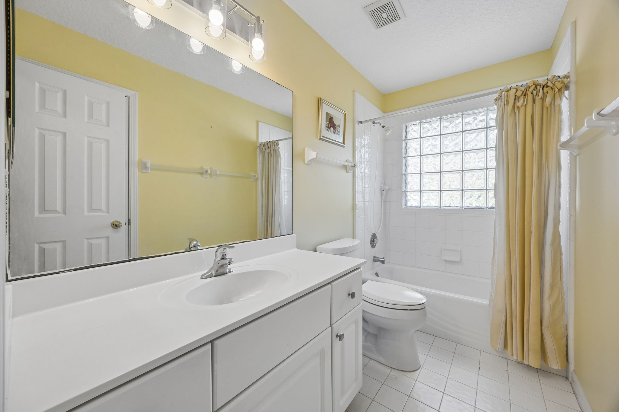 The guest bath is neatly arranged and conveniently located for everyday use.