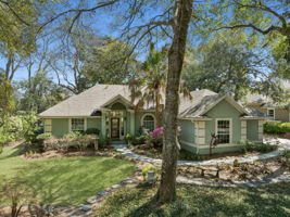 Tucked beneath a canopy of mature trees, the home makes a graceful first impression.