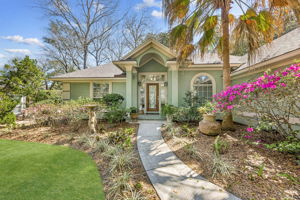 Lush landscaping and flowering color soften the architecture, while Ring security features add convenience and peace of mind.