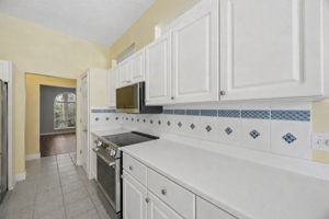 Thoughtful architectural openings above the cabinetry keep the kitchen feeling open rather than enclosed.