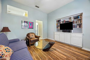 A flexible secondary living area currently serves as an office and den, but can easily function as a bedroom.