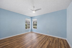 An additional bedroom offers flexibility for guests, hobbies, or work-from-home needs, while tall ceilings, abundant glass, and Minka ceiling fans enhance the home’s open, comfortable feel.