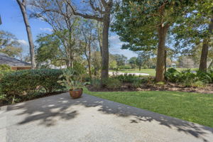 The rear of the home is where the architecture really begins to shine, with a broad patio opening to the golf course setting.