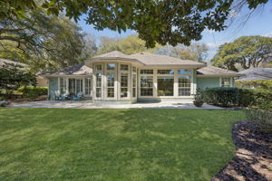 A distinctive wall of windows brings in natural light while framing the backyard and fairway beyond.