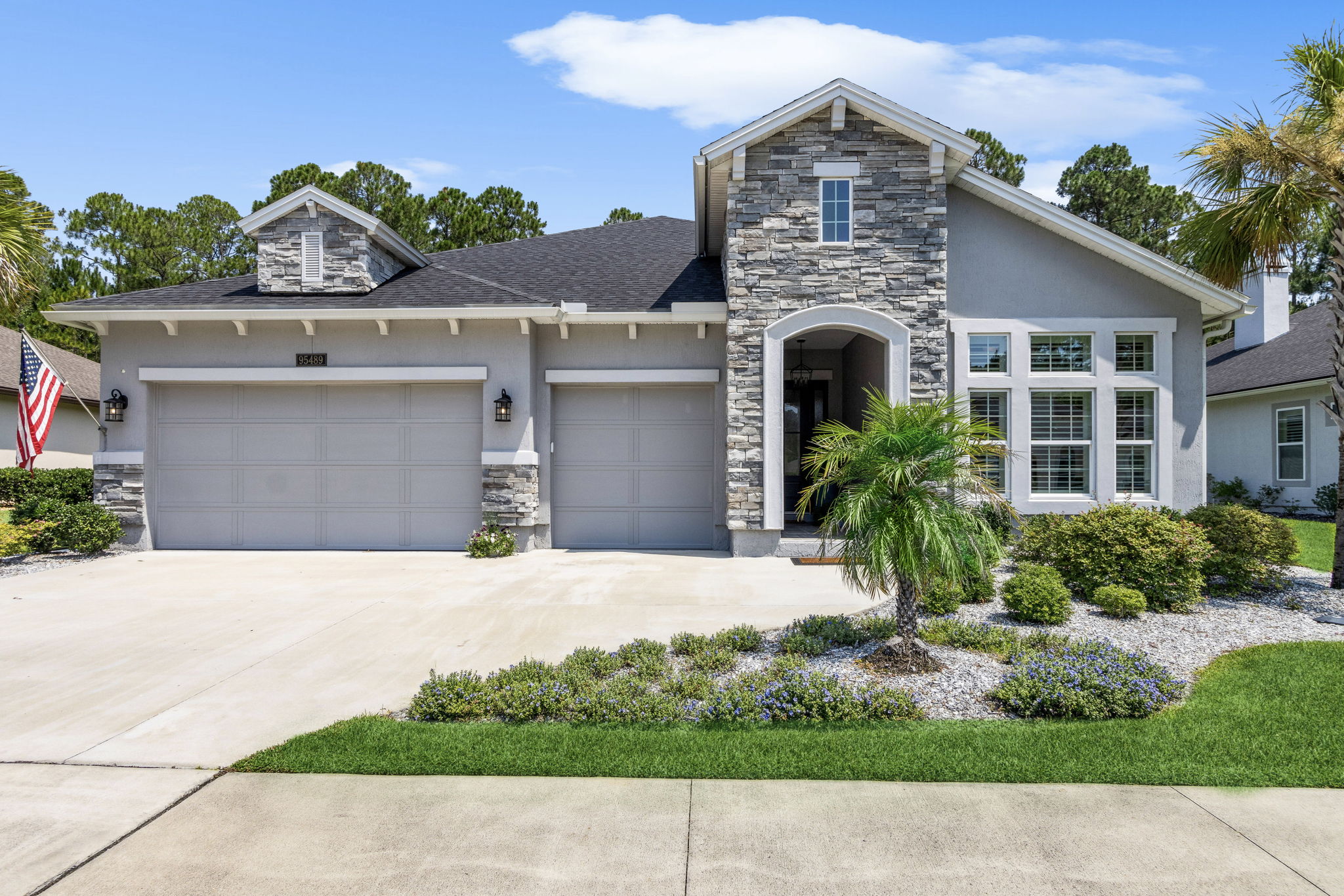 ... with attached 3-bay garage with shark floors,  built-in storage, and room for your golf cart!