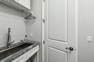 Laundry is upgraded with cabinets and laundry sink with granite surround