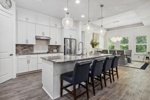 The open floorplan has the family room conveniently flowing to the kitchen and dining areas ...